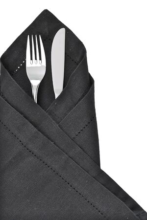 Knife and Fork wrapped in a black napkin as a table settingの写真素材