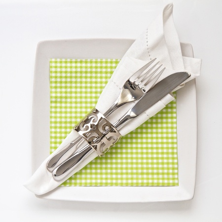 Table place setting with checkered serviette isolated on whiteの写真素材