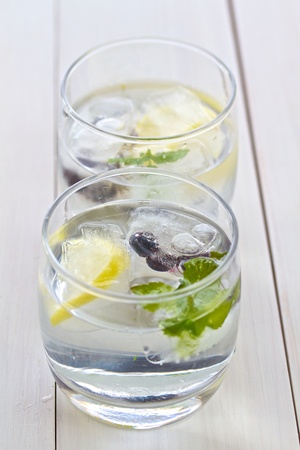 Ice cubes with fruit in a glasses of water の写真素材