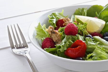 Healthy salad with chicken and berriesの写真素材