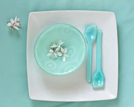 Table setting with flowers and glass bowls and spoonsの写真素材