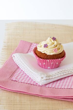 Cupcake with white icing and decoratedの写真素材