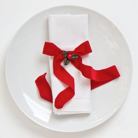 Table setting with napkin and red Christmas ribbonの写真素材
