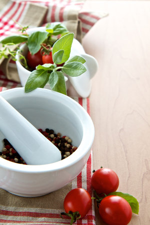 Herbs with peppercorns and tomatoesの写真素材