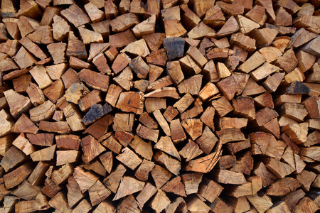 Chopped wood stacked as a backgroundの写真素材