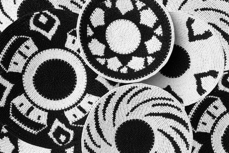 Woven baskets as a background made with black and white plastic coated telephone wire by African craftsmenの写真素材