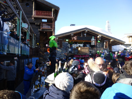 Val d'Isere, France - March 17, 2016: A busy bar on the slopes as people party in the sunshine
