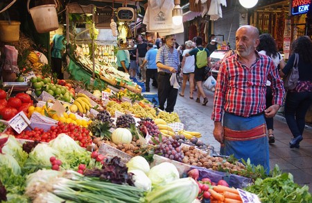 stanbul, Turkey - September 26, 2015: Tourists and locals walking past the fruit and veg market stall and its owner on the Asian side of Istanbul.のeditorial素材