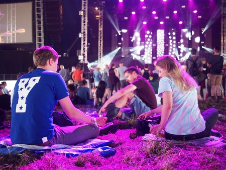 Pilton, United Kingdom - June 26, 2015: Crowd sittting watching music at festivalのeditorial素材