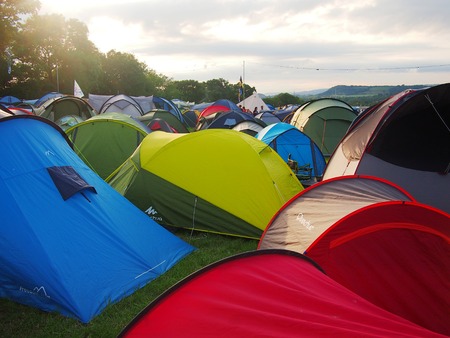 Pilton, United Kingdom - June 24, 2015: Colourful tents packed together at a music festivalのeditorial素材