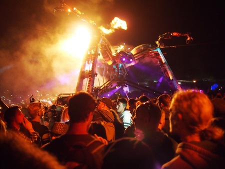 Pilton, United Kingdom - June 28, 2015: Music Festival crowd dance under the giant fire breathing tarantulaのeditorial素材