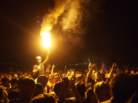 Pilton, United Kingdom - June 27, 2015: Music festival crowd at night, lighting flaresのeditorial素材