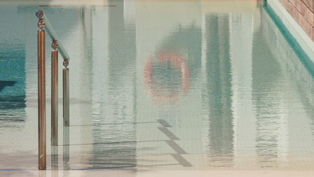 Swimming pool reflection of the stepsの写真素材