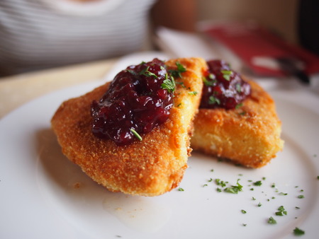 Deep fried crispy camembert cheese on the Trans-Siberian Railway, topped with a raspberry jam.の写真素材