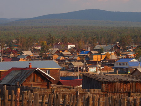 Sunset over the wooden cabins and forests of Khuzir village, Lake Baikal, Siberia, Russiaの写真素材