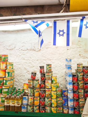 Jerusalem, Israel - 02 June, 2017: Tinned fruit and vegetables for sale at Yehuda market in Jerusalem, decorated with Israeli flagsのeditorial素材