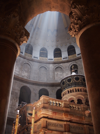 Jerusalem, Israel - 02 June, 2017: Beams of light pierce through the open ceiling inside the Church, illuminating the tomb where Jesus is said to be buried.のeditorial素材