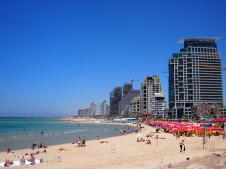Tel Aviv, Israel - 07 June, 2017: A beautiful clear and sunny day, with locals relaxing on the white sandy beaches and the turquoise Mediterrenean Sea.のeditorial素材