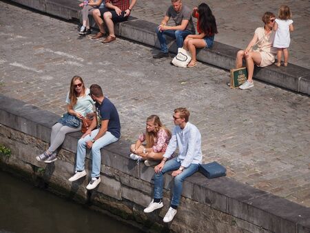 Ghent, Belgium - 26 August 2017: People sitting by the canal in Ghentのeditorial素材