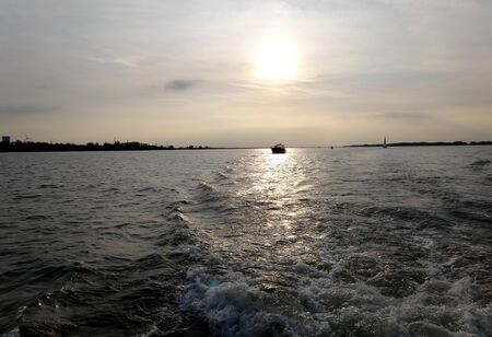 Sailing on Hollands Diep with sun backlightの写真素材