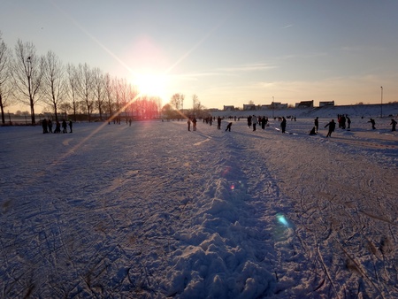 Ice skating during sunsetの写真素材