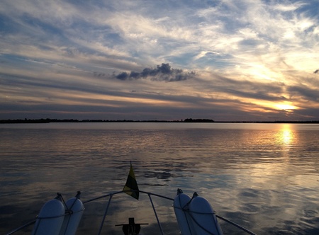 Sunset on water from boatの写真素材