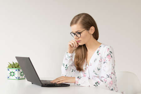 Young businesswoman working from home with a laptopの写真素材