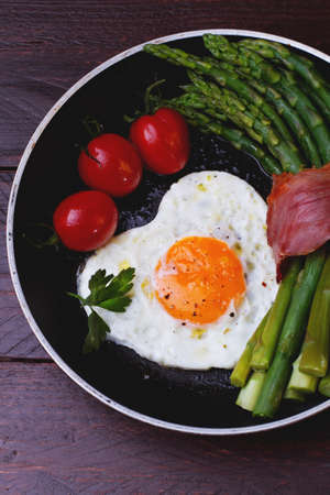 Asparagus in a pan with baconの写真素材