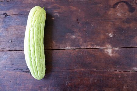 Fresh bitter gourd on wooden floorsの写真素材