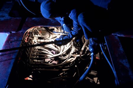 The mechanic is repairing the engine. at nightの写真素材