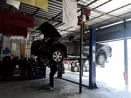 The mechanic is fixing the lower part of the car Pictures about the automotive industryの写真素材