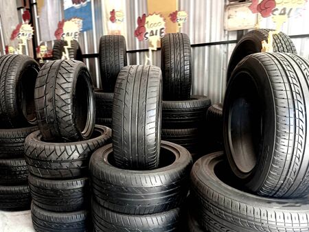 Tires are stacked and exhibited for sale. Images about the automobile industryの写真素材