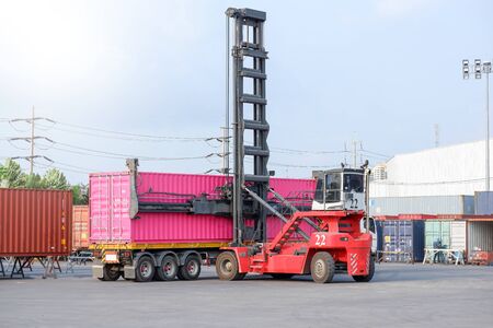 Container stacker, load the container into the truck. Transportation conceptのeditorial素材