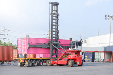 Container stacker, load the container into the truck. Transportation concept