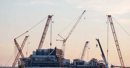 Construction site and sunset, beam, steel structure, build large residential buildings on the construction siteの写真素材