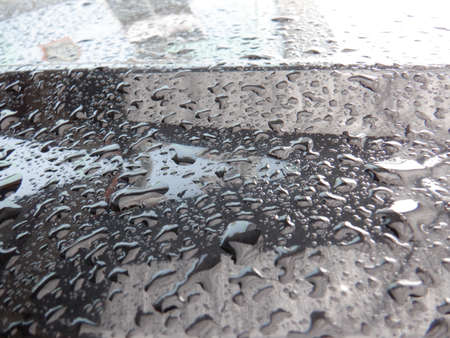 water droplets on the car after the rainの写真素材