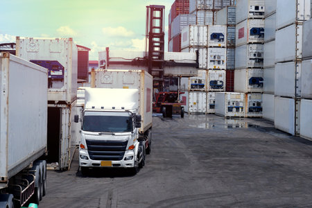 container forklift and load the containers on the truck trailer in the port against the background of the containers.の写真素材