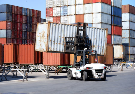 Forklift driver in industrial container warehouseの写真素材