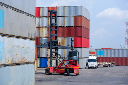 forklift truck Container boxes in a logistic yard with a stack of containers in the background.の写真素材