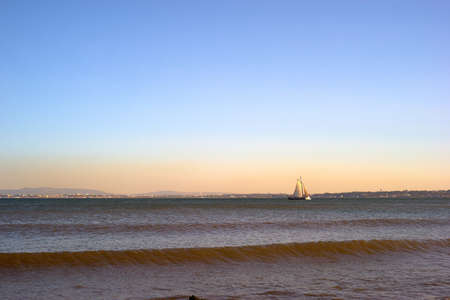 Sailboat in the evening redの写真素材