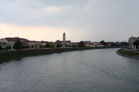 A long view of saint Zeno tower across Adige river