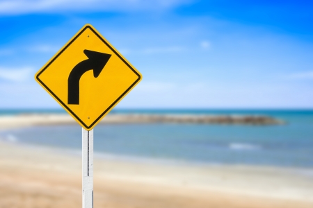 Curved Road Traffic Sign with a Backgroundの写真素材