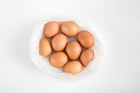 Top view of eggs in  plastic bag on white background.の写真素材