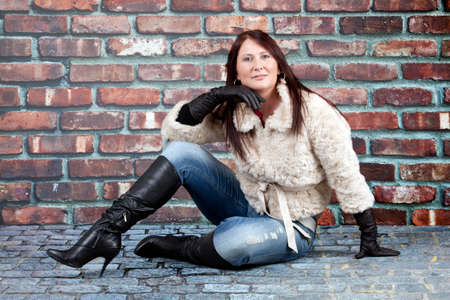 young woman over grey background.  Portrait of a beautiful  woman, over a gray backgroundの写真素材