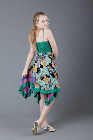 young happy girl.  little girl on a gray backgroundの写真素材
