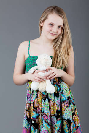young happy girl.  little girl on a gray backgroundの写真素材
