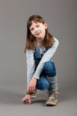 young happy girl.  little girl on a gray backgroundの写真素材