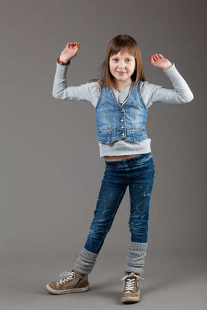 young happy girl.  little girl on a gray backgroundの写真素材