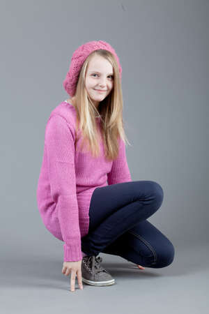 young happy girl.  little girl on a gray backgroundの写真素材
