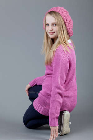 young happy girl.  little girl on a gray backgroundの写真素材